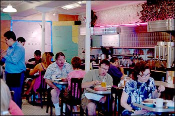 Photo Showing Tables for Two and the Counter